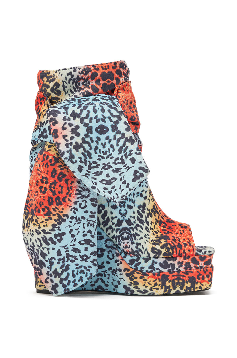 The AKIRA GOLD VENEZIO MULTI COLOR CHEETAH PRINT WEDGE BOOTIE is a bold, high wedge sandal with an open toe, ankle cuff, and vibrant multi-color cheetah print—perfect for Y2K fashion lovers seeking a standout platform sole. 4