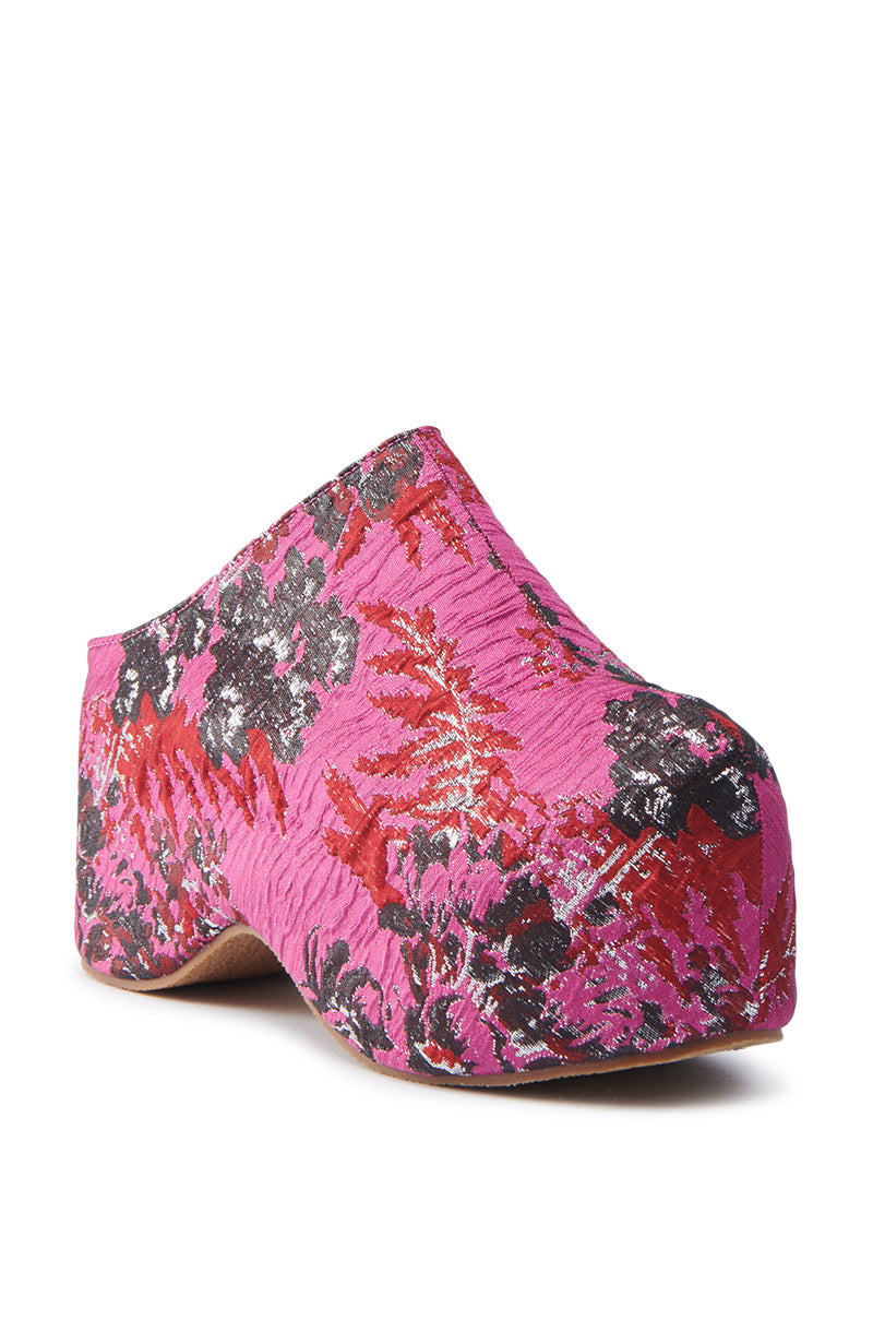 Meet the AZALEA WANG VESTA PINK MULTI BROCADE CLOG, a chic platform shoe showcasing a vibrant pink, red, and black floral brocade pattern. Its closed-toe design and intricate floral motifs add depth and texture, making it a standout fashion piece.