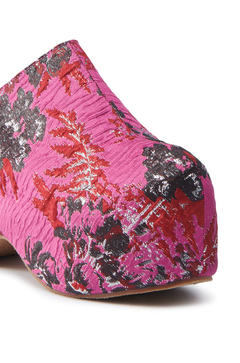Close-up of the AZALEA WANG VESTA PINK MULTI BROCADE CLOG, highlighting a textured surface with pink, red, silver, and black floral pattern. This clog features a platform and wooden sole with a rounded toe.