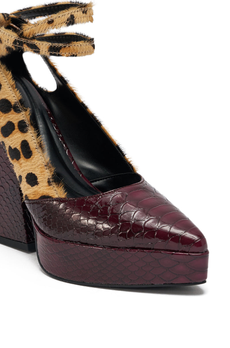 Close-up of the AZALEA WANG VEVELYN MULTI CHUNKY PUMP, featuring a burgundy faux snakeskin platform heel, cheetah-print heels, leopard-print fur sides, black interior, and an ankle strap with a tie.