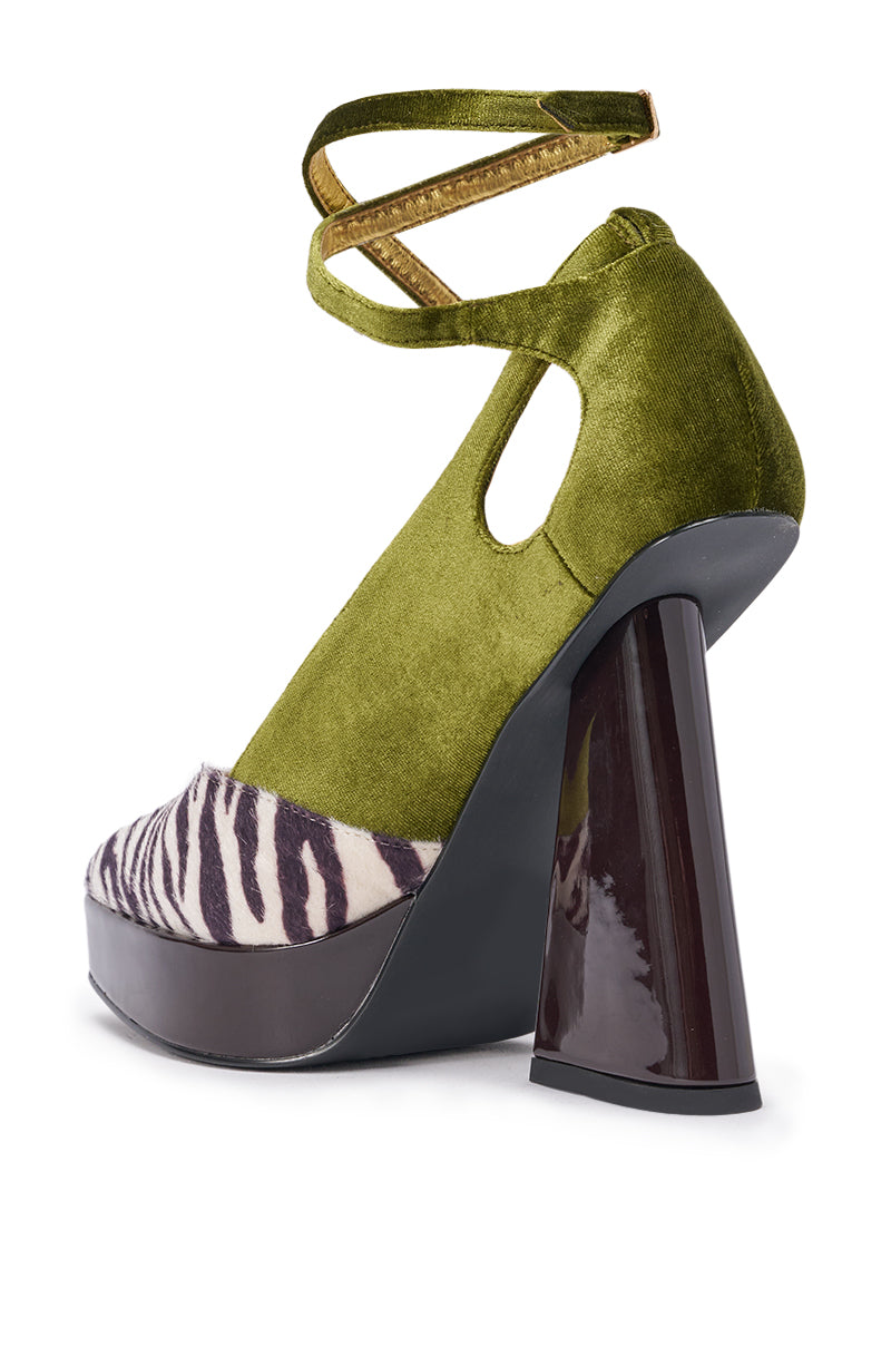The AZALEA WANG VEVELYN OLIVE BLOCK PUMP features an olive green velvet upper, a gold ankle strap, a zebra print toe inspired by heeled sandals, and a chunky glossy dark brown heel. 5