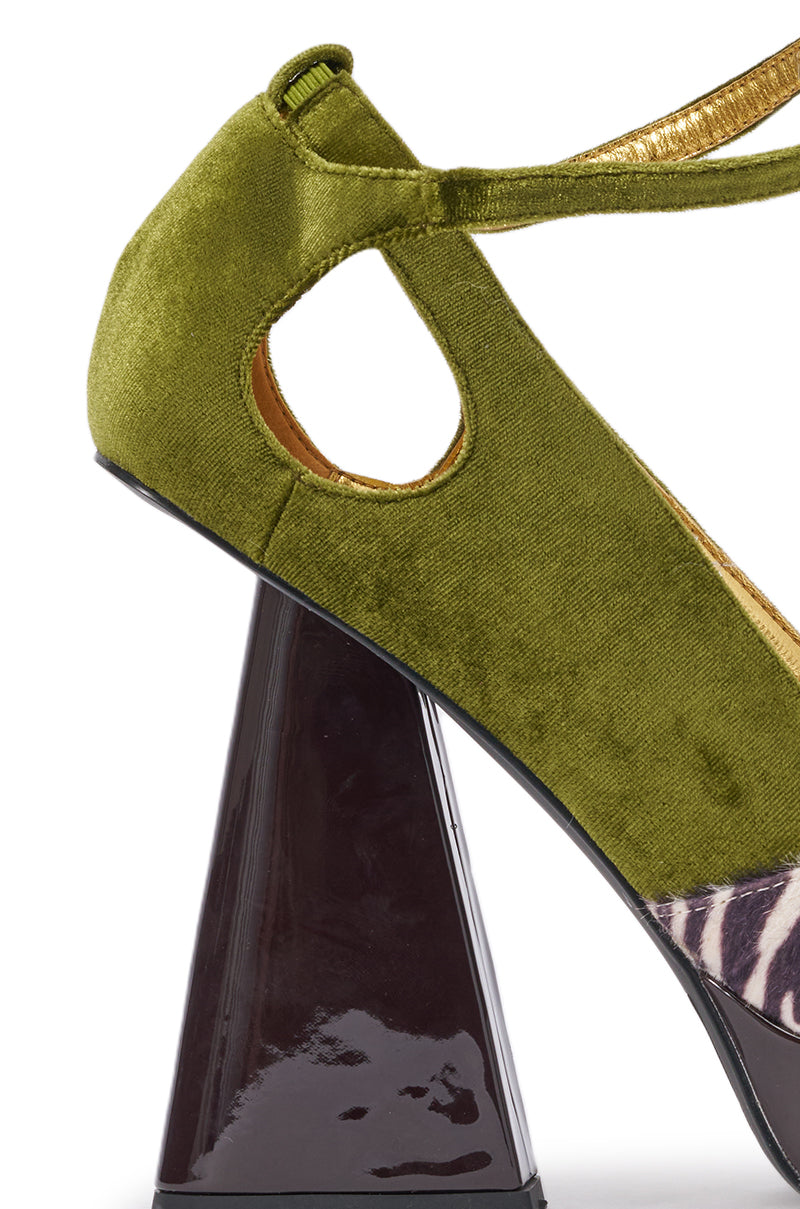 The AZALEA WANG VEVELYN OLIVE BLOCK PUMP features green velvet with a triangular cutout, a shiny dark brown geometric heel, and a striking black and white zebra print on the front for a modern look. 6