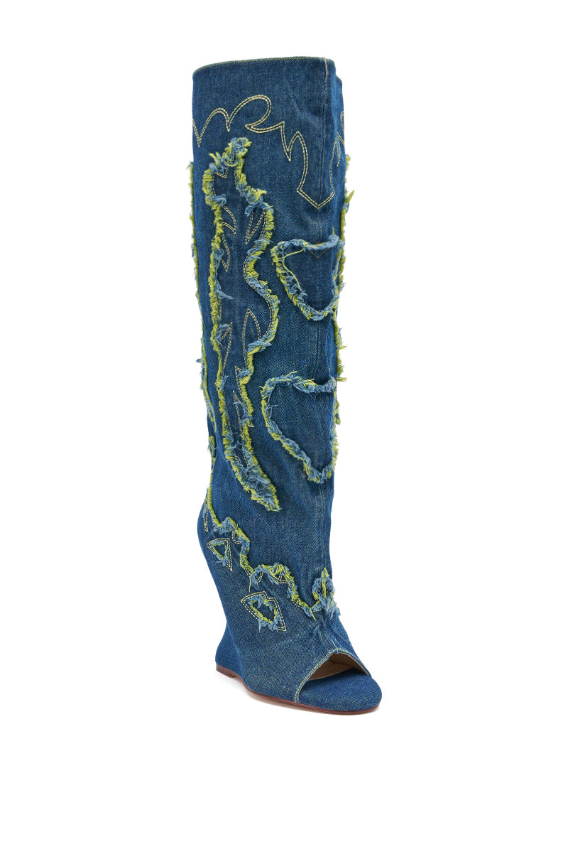 The AZALEA WANG VIANCA GREEN MULTI DENIM WEDGE BOOT is a knee-high wedge boot with frayed green stitching, raw-edged appliqué, an open toe, and a trendy wedge heel.