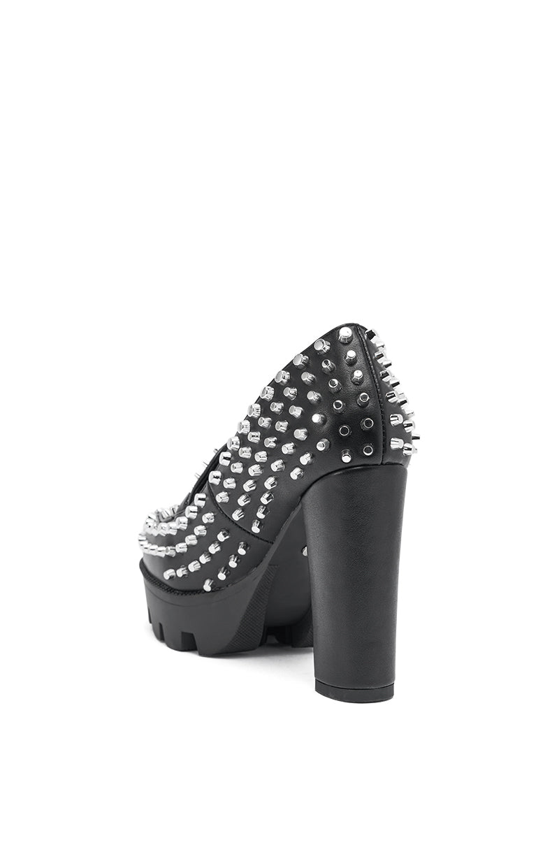 The AKIRA GOLD VICTOIRE BLACK STUDDED PUMP LOAFER is a black loafer with a chunky heel, platform lug sole, and silver spikes along the back and sides, displayed on a white background. 5