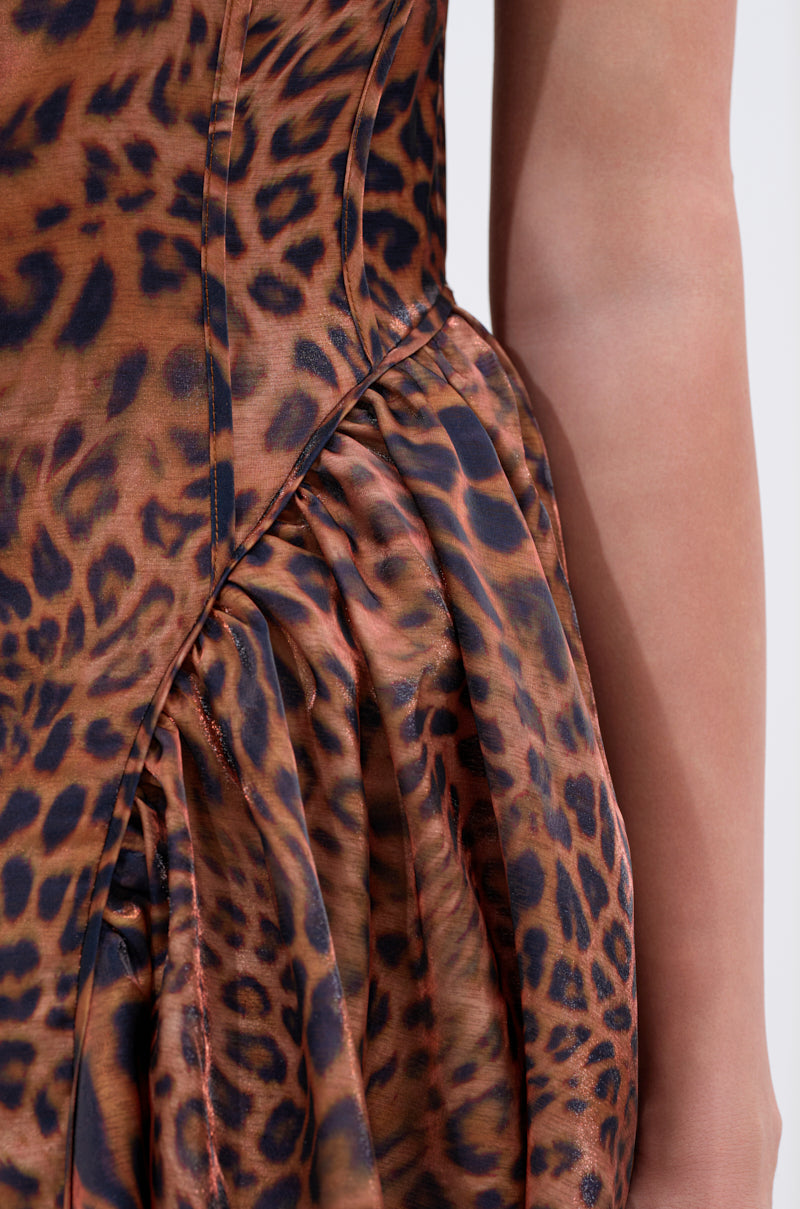 Close-up of a person wearing the CHEETAH SISTERS MIDI DRESS featuring a brown and black leopard print and ruched waist, with their bare arm visible on the right.