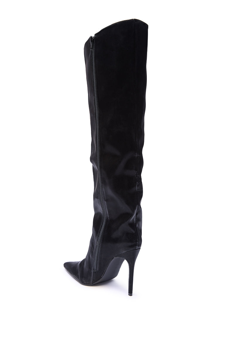 The AZALEA WANG VIETTA BLACK LIQUID LUXE STILETTO BOOT is a black faux leather knee-high boot with a pointed toe, side zipper, and high stiletto heel, displayed in profile against a white background.