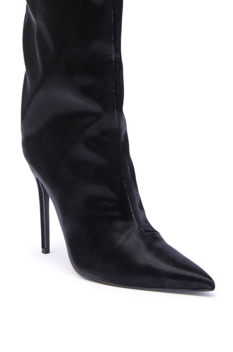 A close-up of the AZALEA WANG VIETTA BLACK LIQUID LUXE STILETTO BOOT, featuring a black faux leather pointed toe, high heel, and sleek design, shown against a white background.