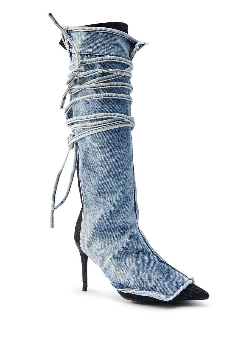The AZALEA WANG VILLAREAL DENIM BOOT WITH TIES is a stunning knee-high stiletto featuring a pointed toe, light gray laces wrapped around the shaft, and a slim black heel, creating a sophisticated touch to this stylish denim boot.