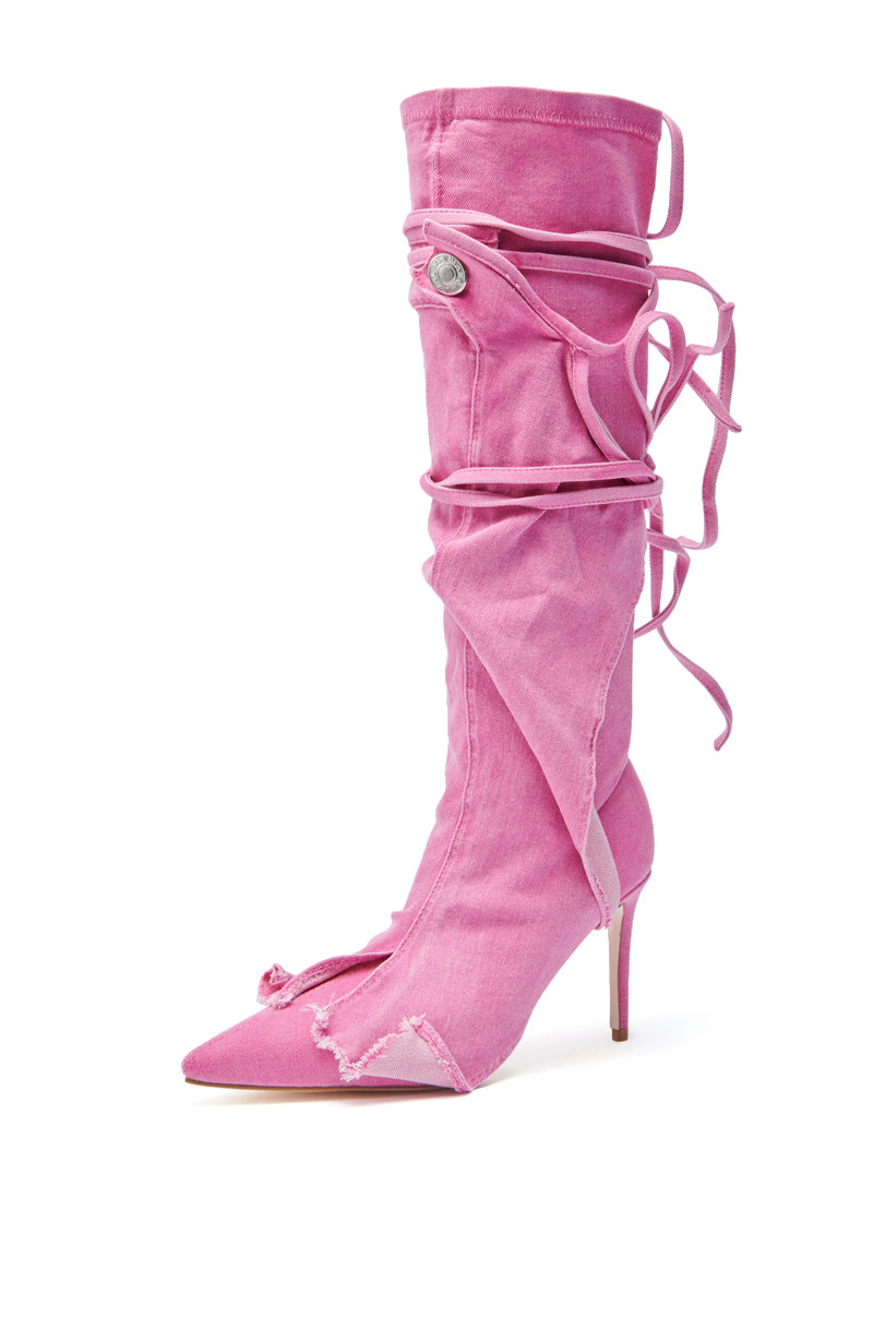 The AZALEA WANG VILLAREAL PINK STRAPPY BOOT is a knee-high pointed-toe stiletto with a distressed pink denim upper, wraparound laces, and a decorative button for standout style.