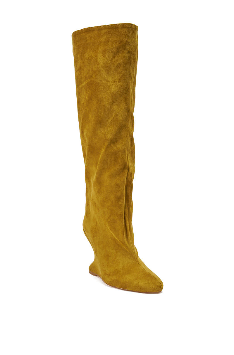 The AZALEA WANG VINCE MUSTARD FAUX SUEDE WEDGE BOOT features a tall, slouchy silhouette in mustard yellow with a pointed toe, crafted from soft faux suede and displayed against a plain white background.