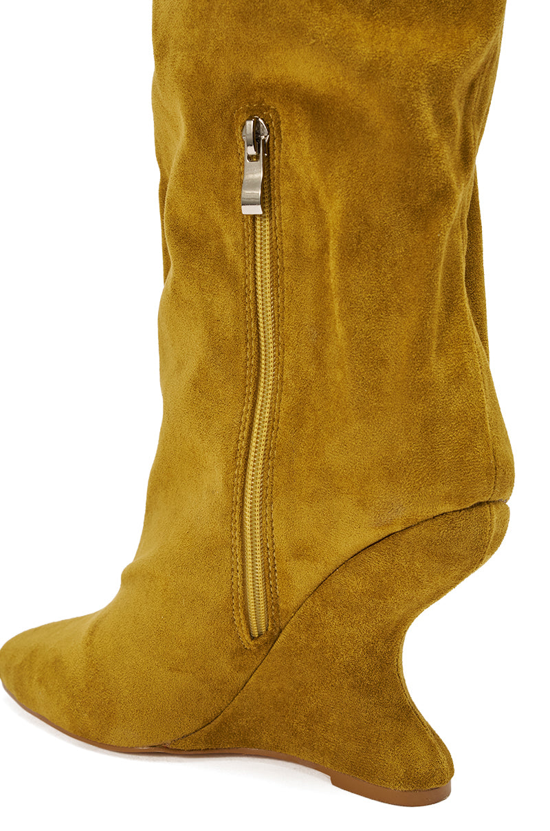A close-up of the AZALEA WANG VINCE MUSTARD FAUX SUEDE WEDGE BOOT, showcasing its sculpted wedge heel, pointed toe, and vertical side zipper.