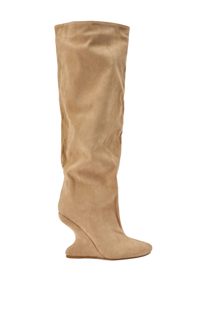 The AZALEA WANG VINCE NUDE FAUX SUEDE WEDGE BOOT features a pointed toe, sculpted wedge heel, and a slightly slouched knee-high shaft, shown in tan faux suede from the side on a white background.