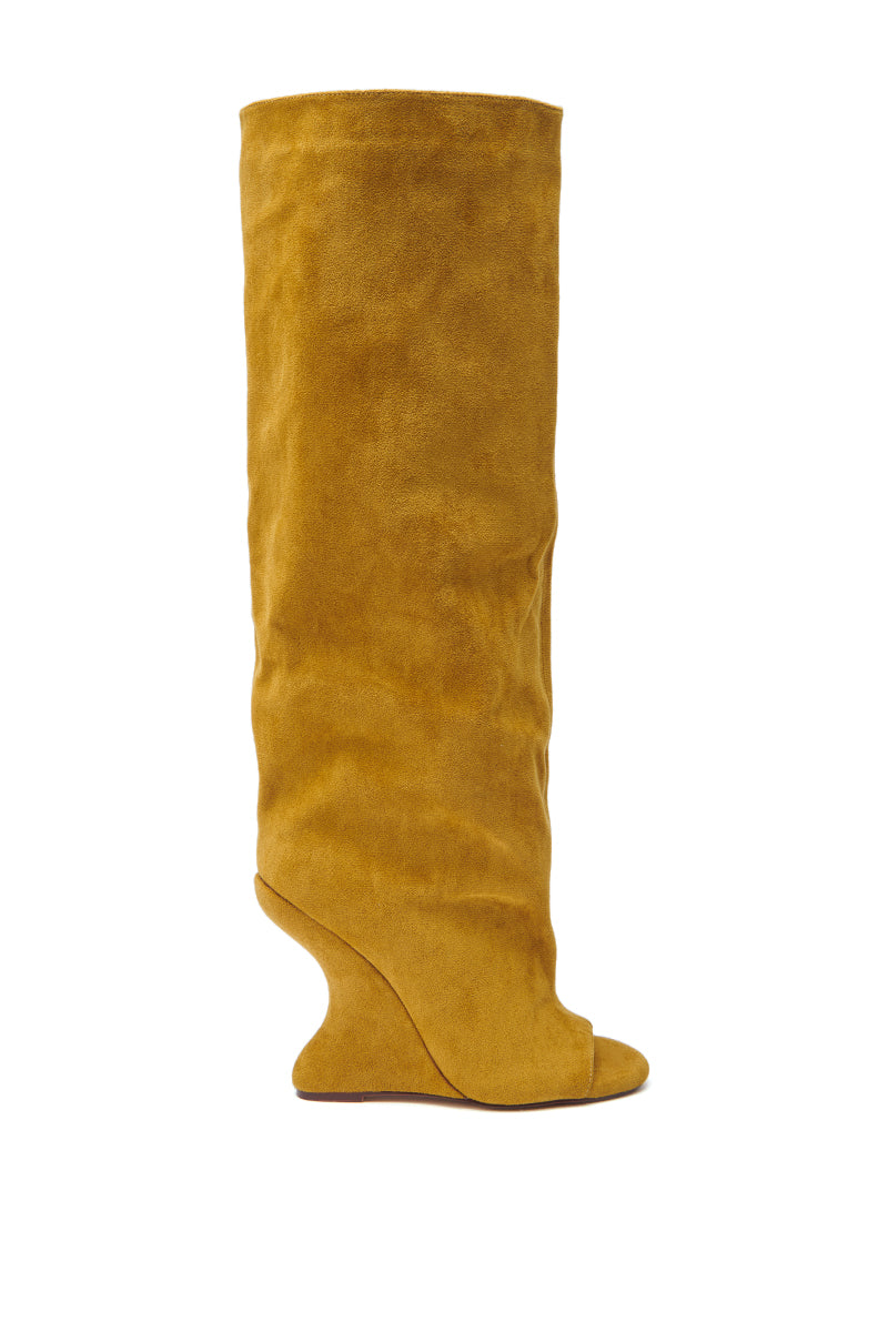 The AZALEA WANG VINCENT MUSTARD SUEDE OPEN TOE BOOT, featuring a tall, slouchy knee-high shaft and inverted wedge heel, is displayed in profile against a white background.
