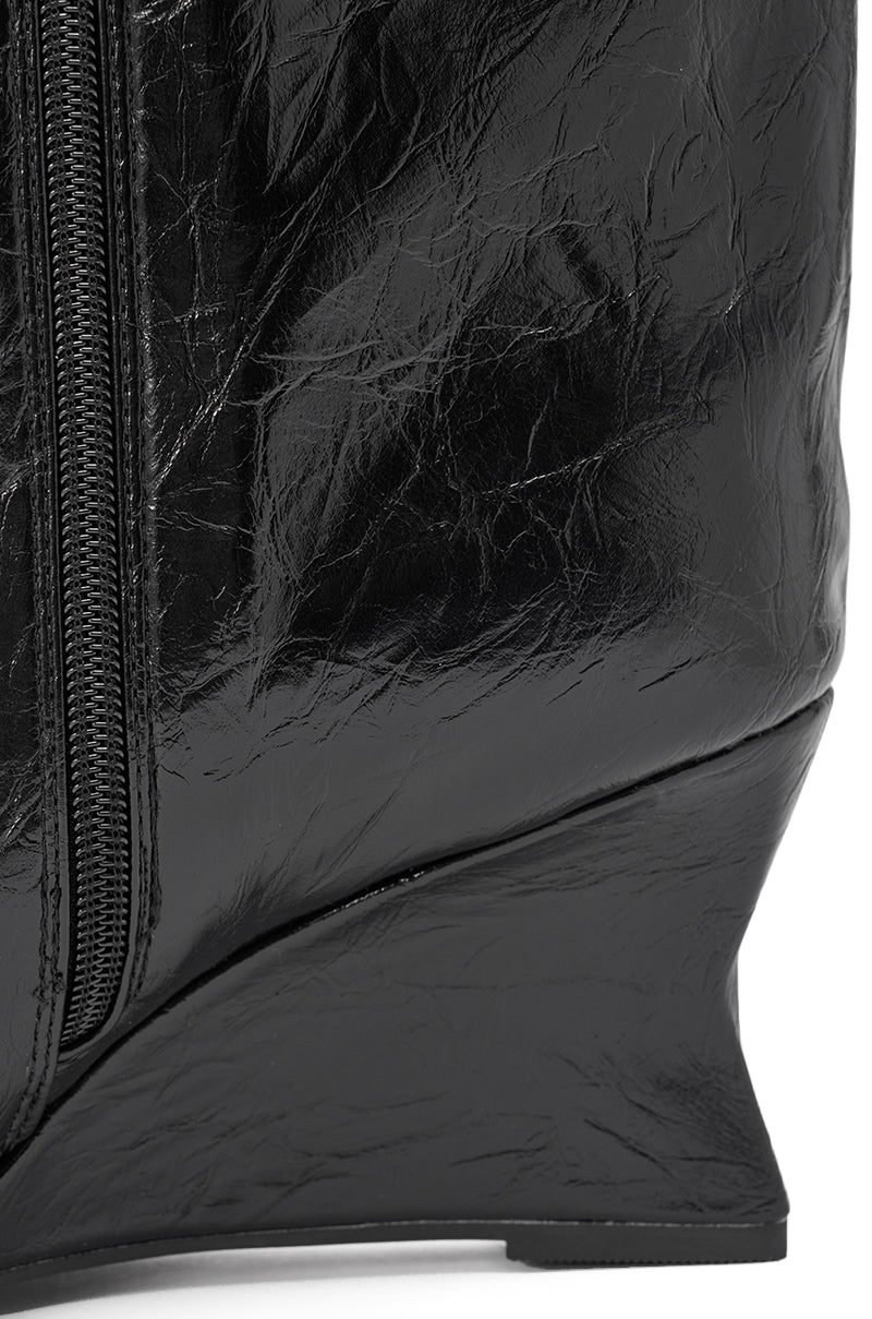 Close-up of the AZALEA WANG VINCI BLACK PU PRINT WEDGE BOOTIE, featuring shiny, crinkled black faux leather, a pointed toe, wedge heel, and a visible left-side zipper. 6