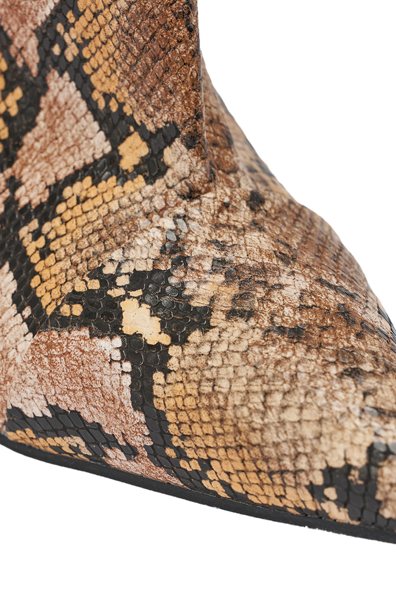 Close-up of the pointed toe wedge on the AZALEA WANG VINCI SNAKE PU PRINT WEDGE BOOTIE, displaying its brown, beige, and black snakeskin pattern with detailed scale-like texture. 9