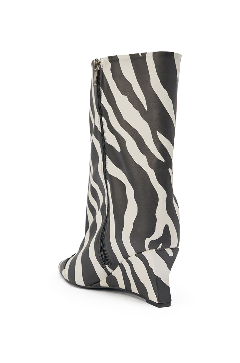 The AZALEA WANG VINCI ZEBRA PU PRINT WEDGE BOOTIE features a black and white zebra print, pointed toe, side zipper, and faux leather construction, shown on a white background. 4
