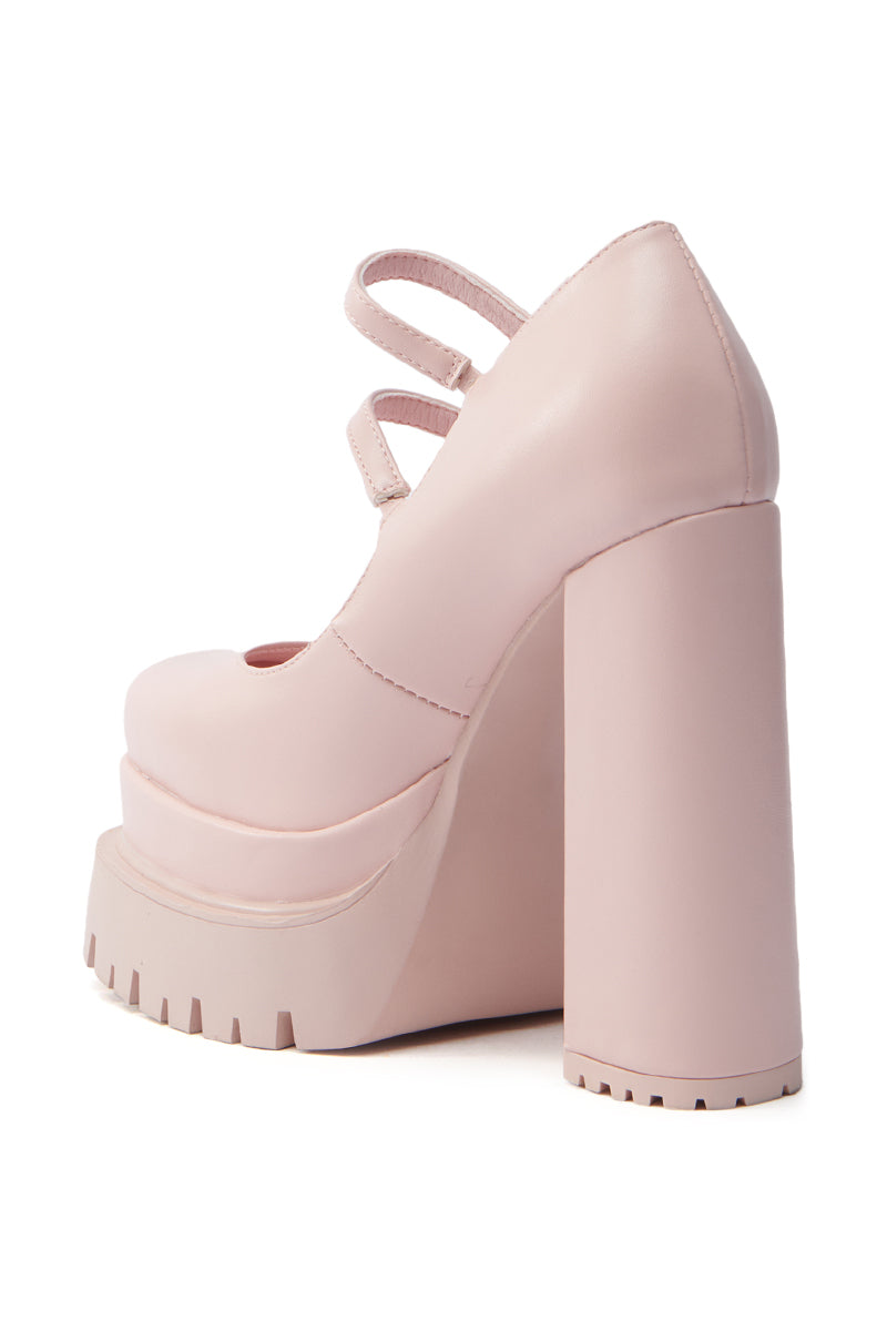 The AZALEA WANG VIOLINA PINK CHUNKY PLATFORM PUMP is a stylish vegan leather high-heeled shoe, showcasing chunky platform soles, a square toe, and two crisscross straps, elegantly set against a plain white background. 4