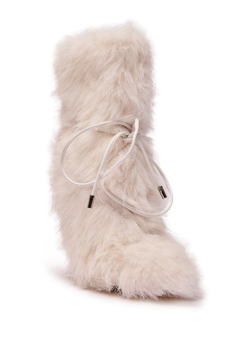 The AZALEA WANG VITYA IVORY FUR BOOTIE is a single white faux fur, mid-calf bootie with a pointed toe, white laces, and a stiletto heel, shown against a plain white background.