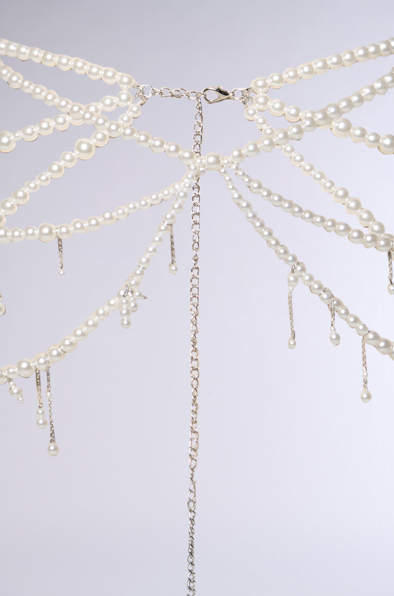 The STAY DRIPPIN PEARL BELT features multiple faux pearl strands and silver chains radiating from a central clasp, with pearl-dangling chains, all set against a light gray background.