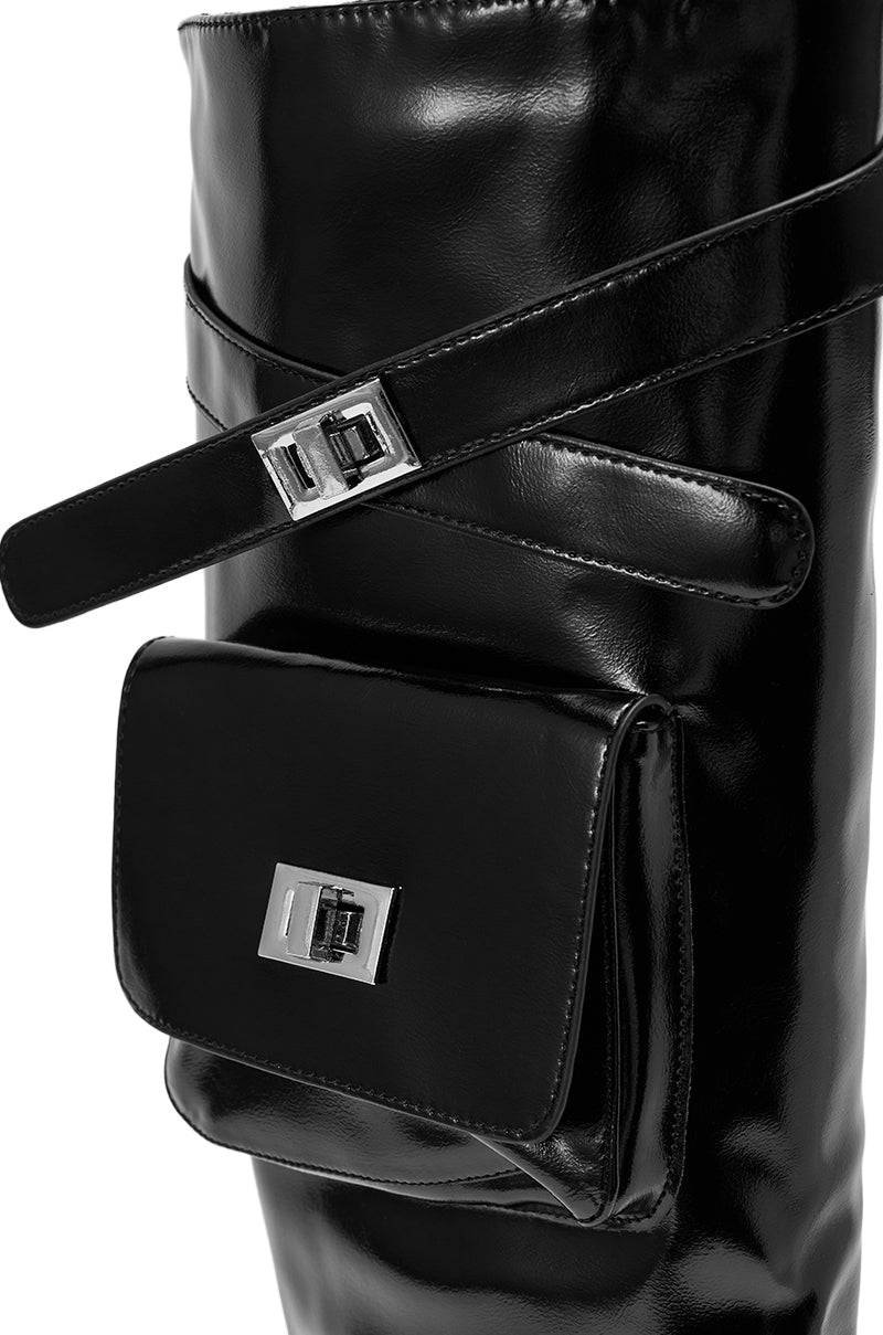 The AZALEA WANG WATERS BLACK STILETTO BOOT WITH POCKETS showcases a shiny black knee-high look with a silver buckle strap and a rectangular pouch featuring a matching silver clasp.
