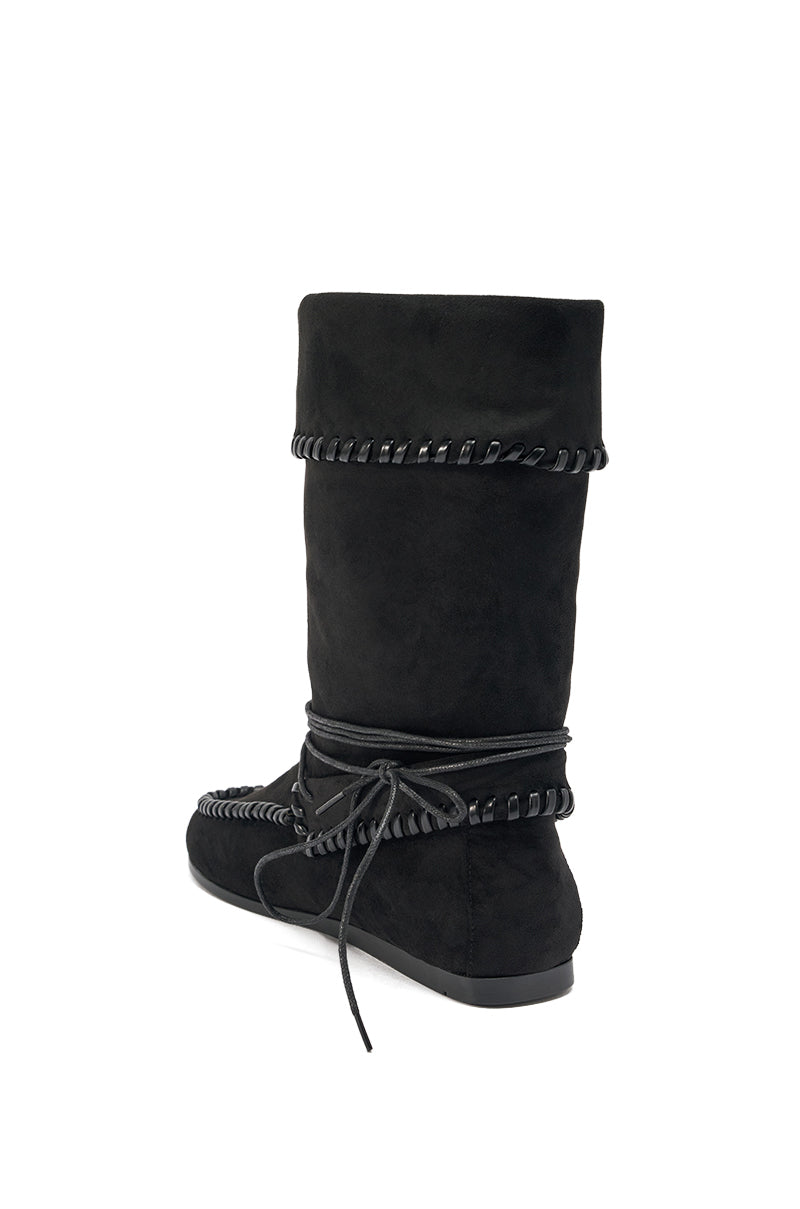 The AZALEA WANG WERET BLACK FLAT BOOTIE is a black faux suede mid-calf bootie with decorative stitching, a wraparound lace tied at the ankle, and a flat rubber sole.