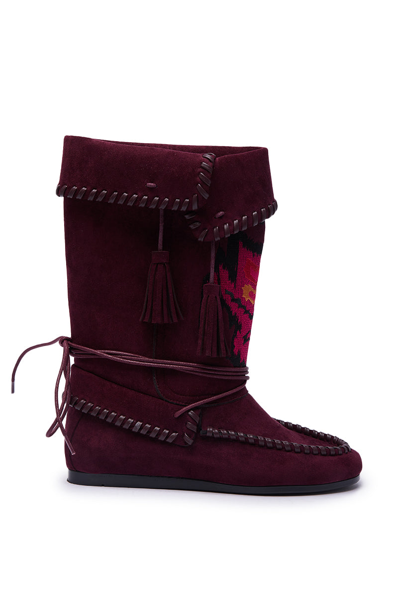 The AZALEA WANG WERET PLUM FLAT BOOTIE is a bohemian-inspired bootie in maroon suede with decorative stitching, tasseled wrap-around laces, a folded top, and a vibrant pink and red side pattern. 3