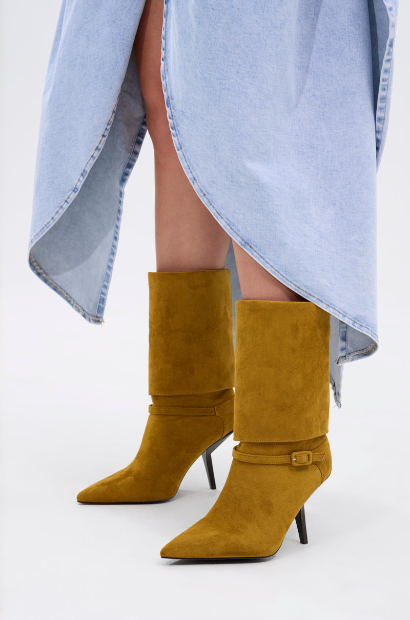 A person wearing a light blue asymmetrical denim skirt and the AZALEA WANG WINDING OLIVE STILETTO BOOTIE.