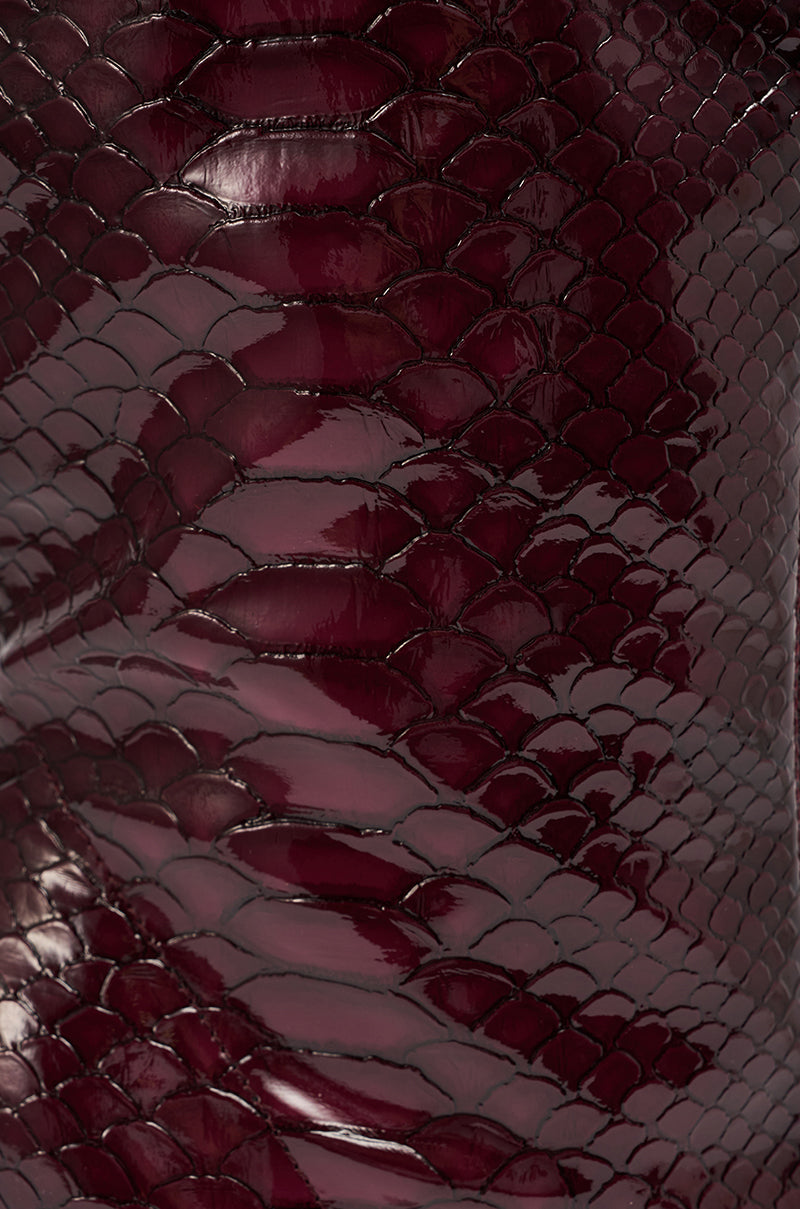 Close-up of the AZALEA WANG WINGROVE BURGUNDY CHUNKY HEEL CROCODILE BOOTIE’s shiny, dark burgundy faux crocodile texture, featuring detailed overlapping scale patterns with a glossy finish.