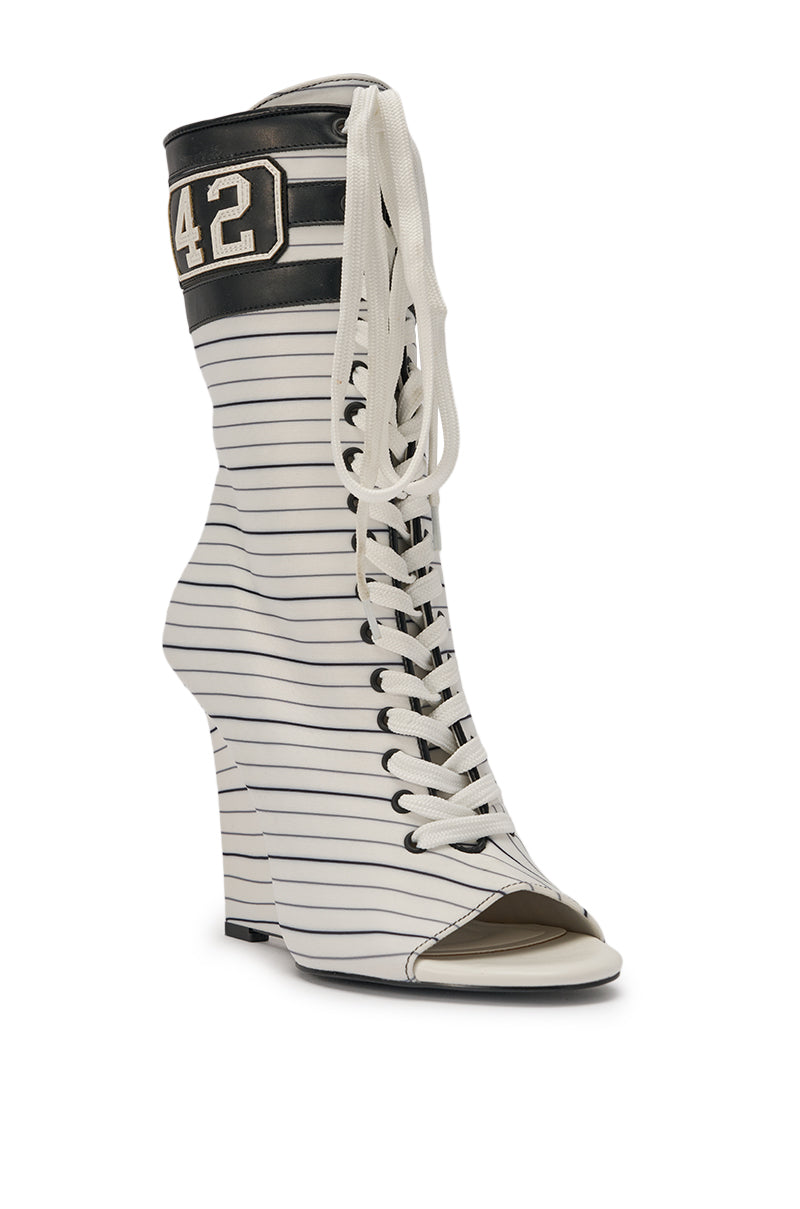 The AZALEA WANG WYATT WHITE STRIPED NAUTICAL OPEN TOE BOOTIE is a mid-calf, high-heeled lace-up featuring black stripes on white, peep-toe design, and the number 42 near the top for a sporty touch. 4