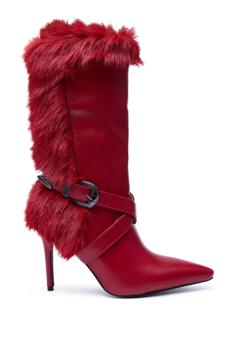 The AZALEA WANG WYLDER RED FUR BOOTIE is a stylish red faux leather mid-calf boot with faux fur trim, a decorative black buckle strap, pointed toe, and stiletto heel.