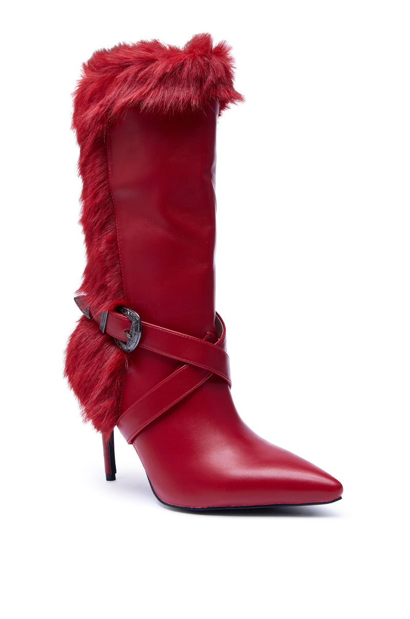 The AZALEA WANG WYLDER RED FUR BOOTIE is a stylish red mid-calf boot featuring a pointed toe, faux fur trim, crisscross leather straps with a silver buckle, and a sleek stiletto heel.