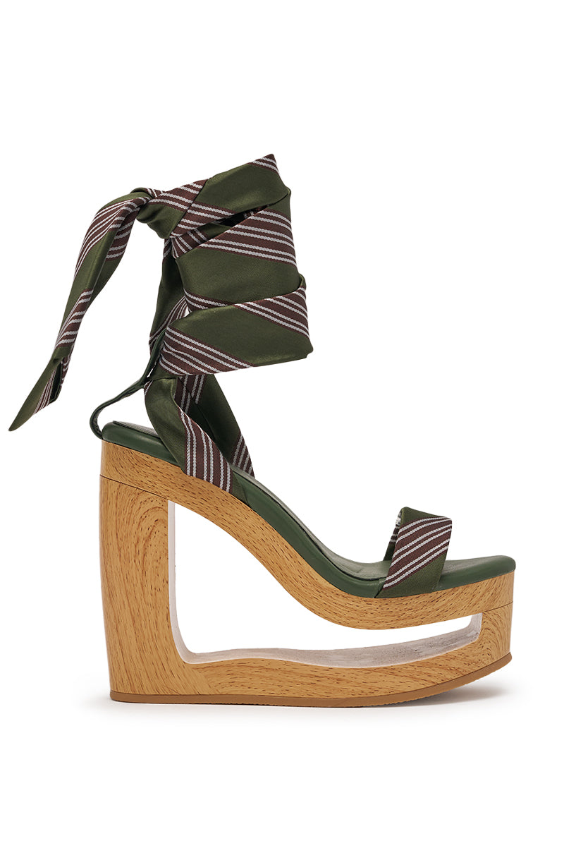 The AKIRA GOLD WYNN GREEN TIE LACE UP NOVELTY WEDGE SANDAL features a green ankle tie, wooden cutout platform wedge heel, open toe, and striped fabric ties. 3