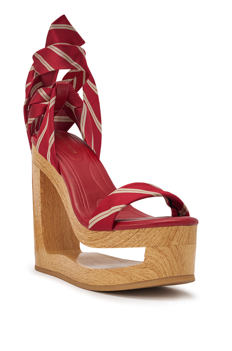 The AZALEA WANG WYNN RED TIE LACE UP WEDGE features a bold striped design, wraparound ankle ties, and a unique wooden cutout platform wedge heel for a sculptural, standout look. 4