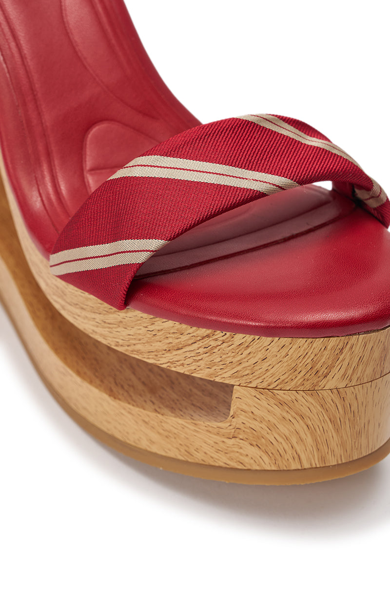 Close-up of the AZALEA WANG WYNN RED TIE LACE UP WEDGE, a red open toe sandal with a thick striped fabric strap and a unique platform wedge heel featuring a carved cutout design. 6