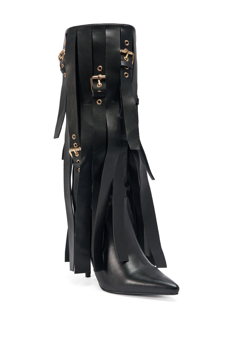 The AZALEA WANG XANTHE BLACK BELT EMBELLISHED STILETTO BOOT is a dramatic, knee-high faux leather boot in black with long fringe, gold buckles, and a pointed toe—an edgy statement piece.