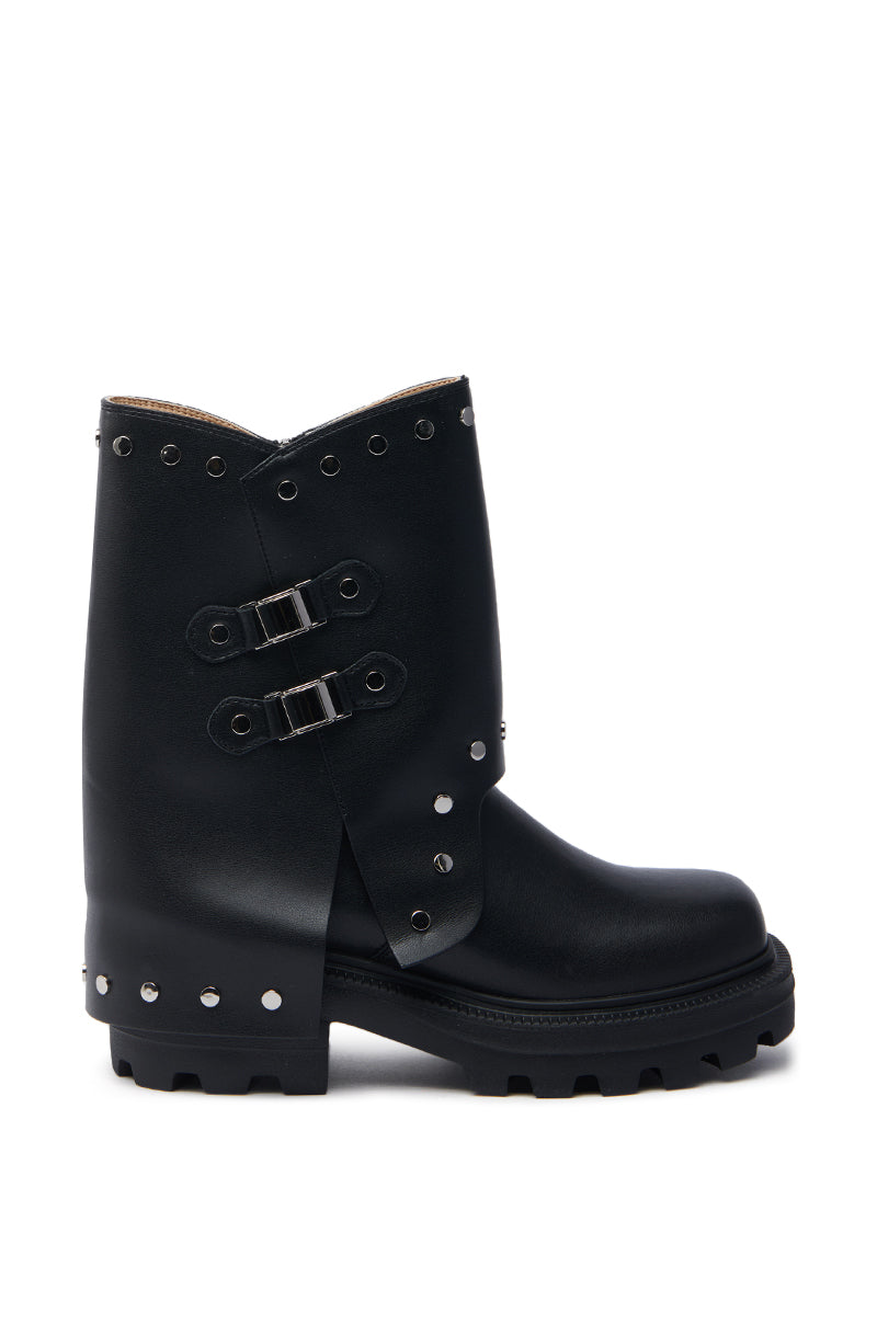 AZALEA WANG XAVIER BLACK WITH METAL FLAT BOOTIE features an overlapping flap, metallic stud trim along the edges, two silver buckle straps on the side, and a thick lugged sole.