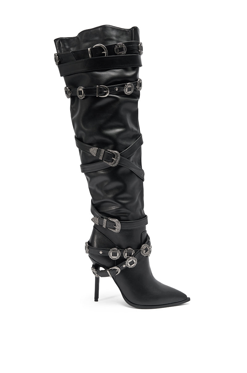 The AKIRA GOLD XERXES BLACK STILETTO METAL EMBELLISHED BOOT is a tall, black faux leather knee-high boot with a pointed toe and multiple silver buckle straps around the shaft and ankle. 3