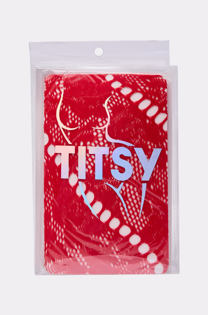 A red package with a white abstract pattern, "TITSY" in large holographic letters, and a woman's silhouette in white line art—ideal for presenting the LACED FEELINGS TIGHTS with their stylish floral pattern.