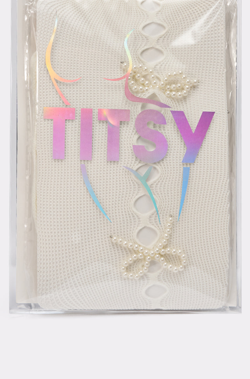 ANGEL SEASON TIGHTS feature white textured fabric like mesh tights, adorned with pearls and packed in clear plastic. "TITSY" appears in shiny iridescent letters beside a minimalist nude female torso line drawing on the packaging. 6