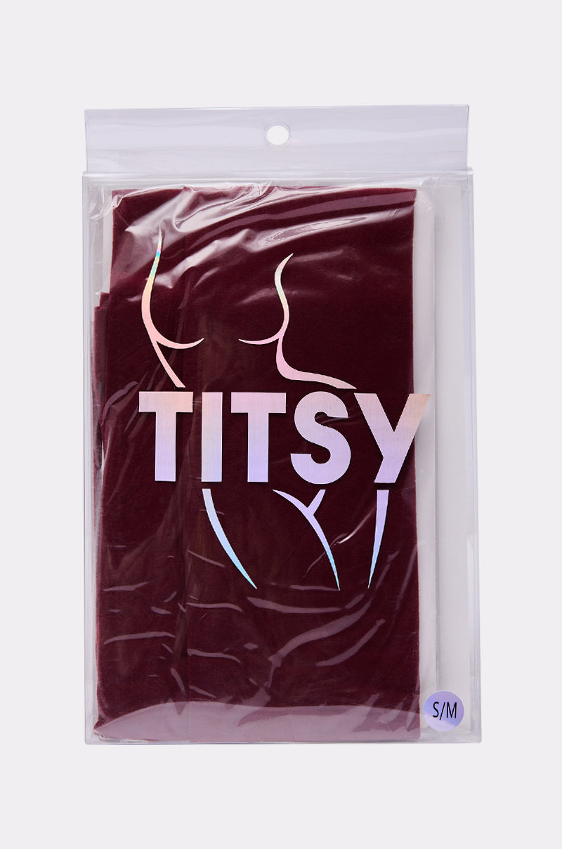 A pair of OXBLOOD OPAQUE TIGHTS, perfect for autumn, comes folded in a clear resealable plastic bag with a curvy outline, bold shiny "TITSY" lettering, and an "S/M" size label at the bottom right corner. 4