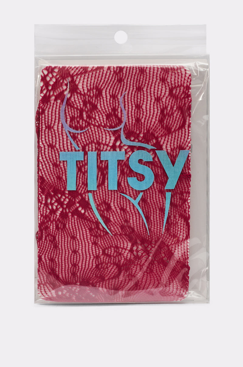 A package of CLASSY VIBES THIGH HIGH STOCKINGS IN RED, featuring lace fabric like lace stockings, "TITSY" in blue letters, and a simple outline of a woman's torso printed on the plastic. 2
