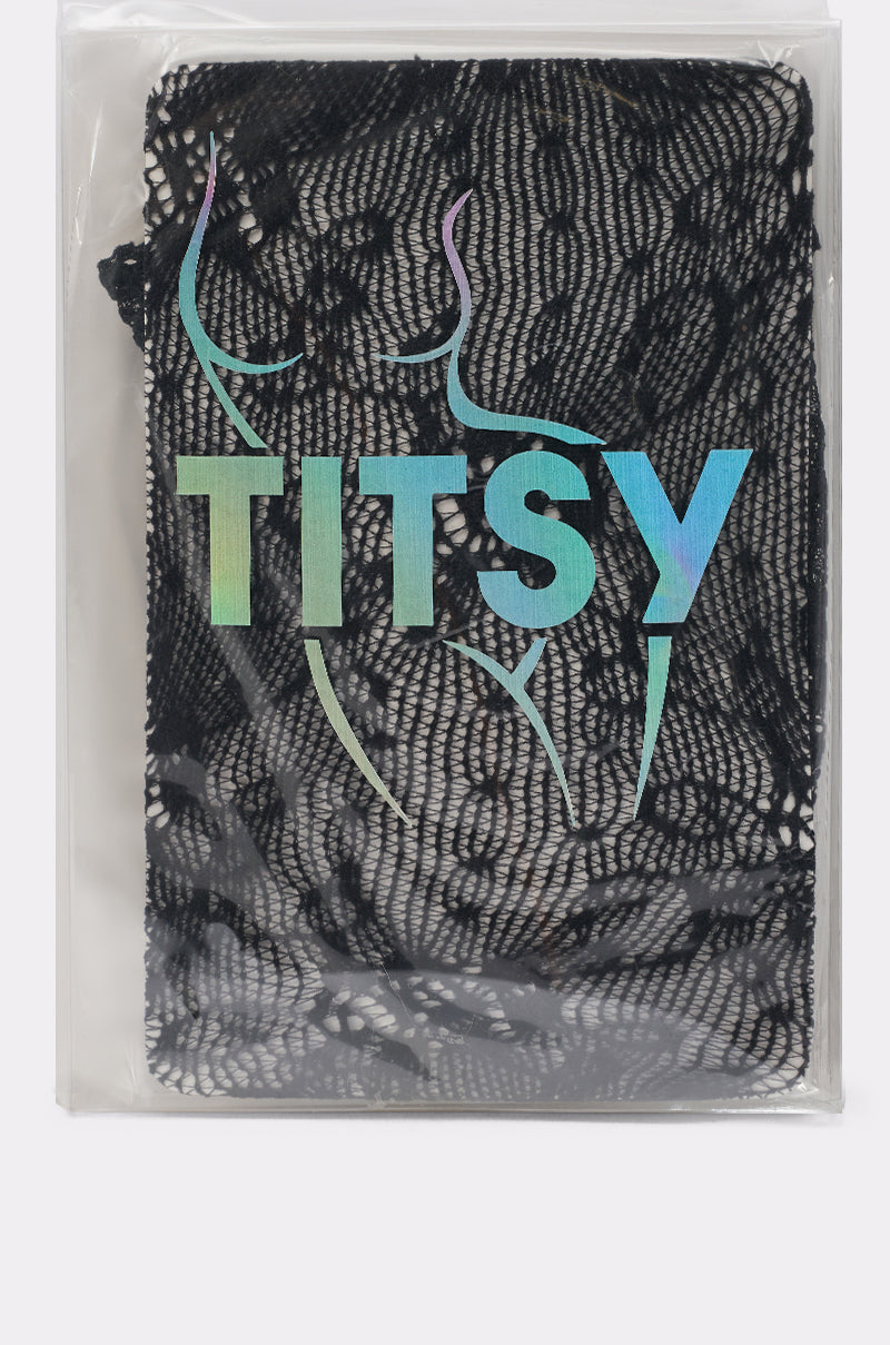 A package of CLASSY VIBES THIGH HIGH STOCKINGS IN BLACK features the brand "TITSY" in iridescent letters above a subtle outline of a woman's silhouette on the front. 3