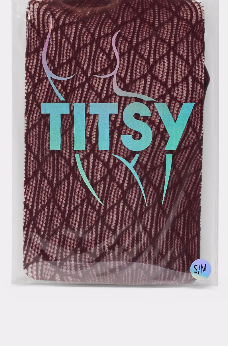 A BELLA TIGHTS package in burgundy fishnet, labeled "TITSY" in bold blue letters with a minimalist torso outline and a small blue circle marking size "S/M" in the corner. 7