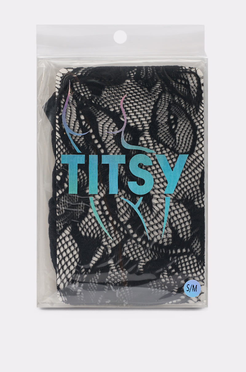 A package of LILI TIGHTS black floral lace lingerie features "TITSY" in blue on the front with an outline of a woman's body; a small "S/M" size label appears in the bottom right corner. 2