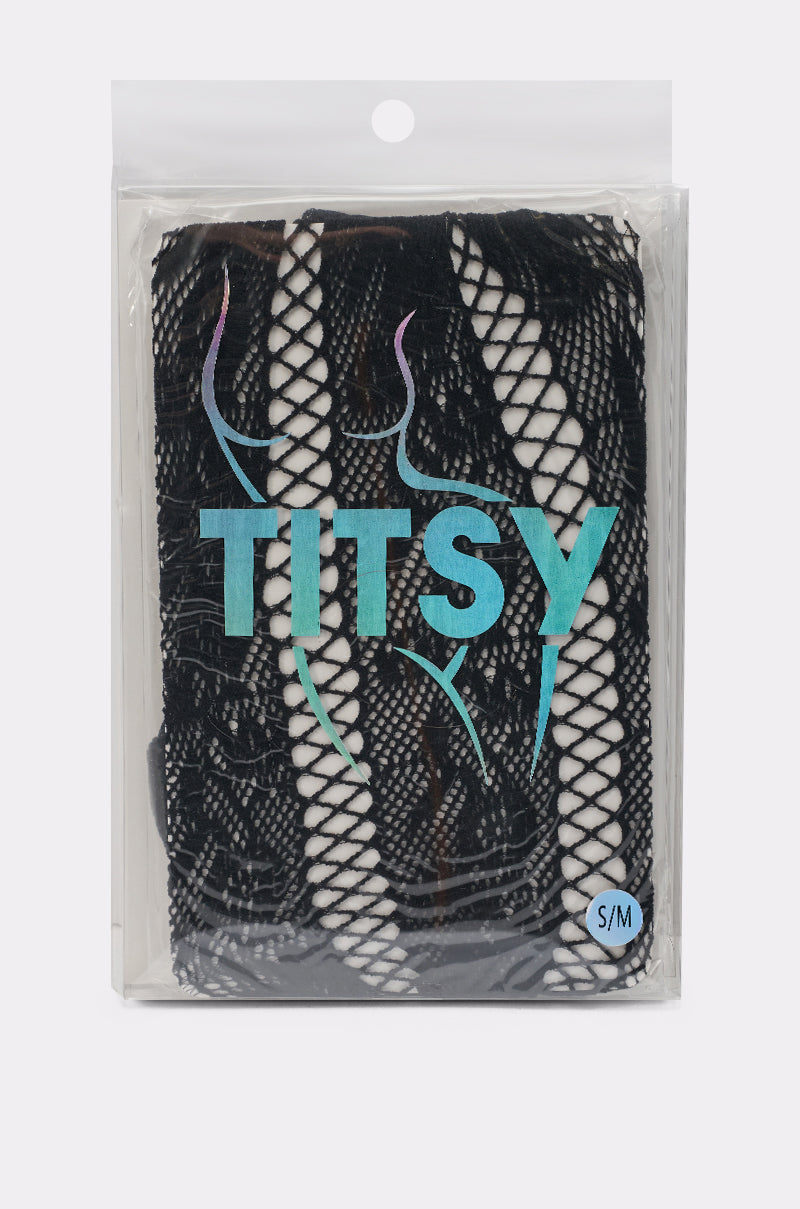 A package labeled "FEMME TIGHTS IN BLACK" contains black fishnet lingerie in size S/M, made from stretchy knit. The clear plastic wrap has a hanging tab and features a blue outline of a curvy silhouette on the front. 3
