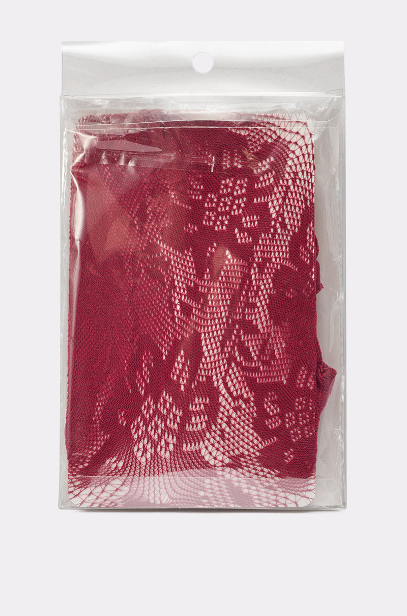 A clear plastic bag with a hanging hole holds folded FOR THE NIGHT LACE TIGHTS in red, featuring a floral lace pattern. 1