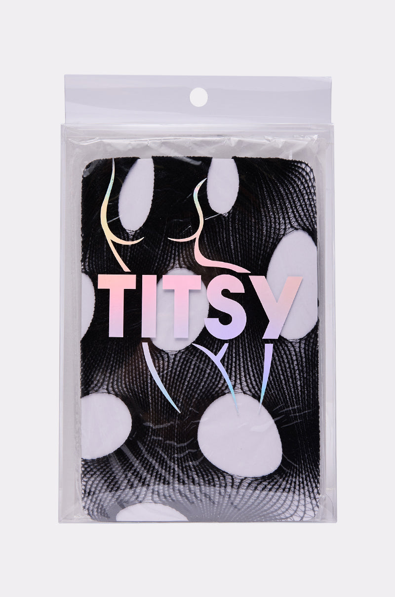 A packaged product labeled "CUT IT OUT TIGHTS" in iridescent letters, with a black and white abstract pattern of large dots and swirling lines. Thin pastel curved lines outline body shapes, hinting at the edgy tights inside.