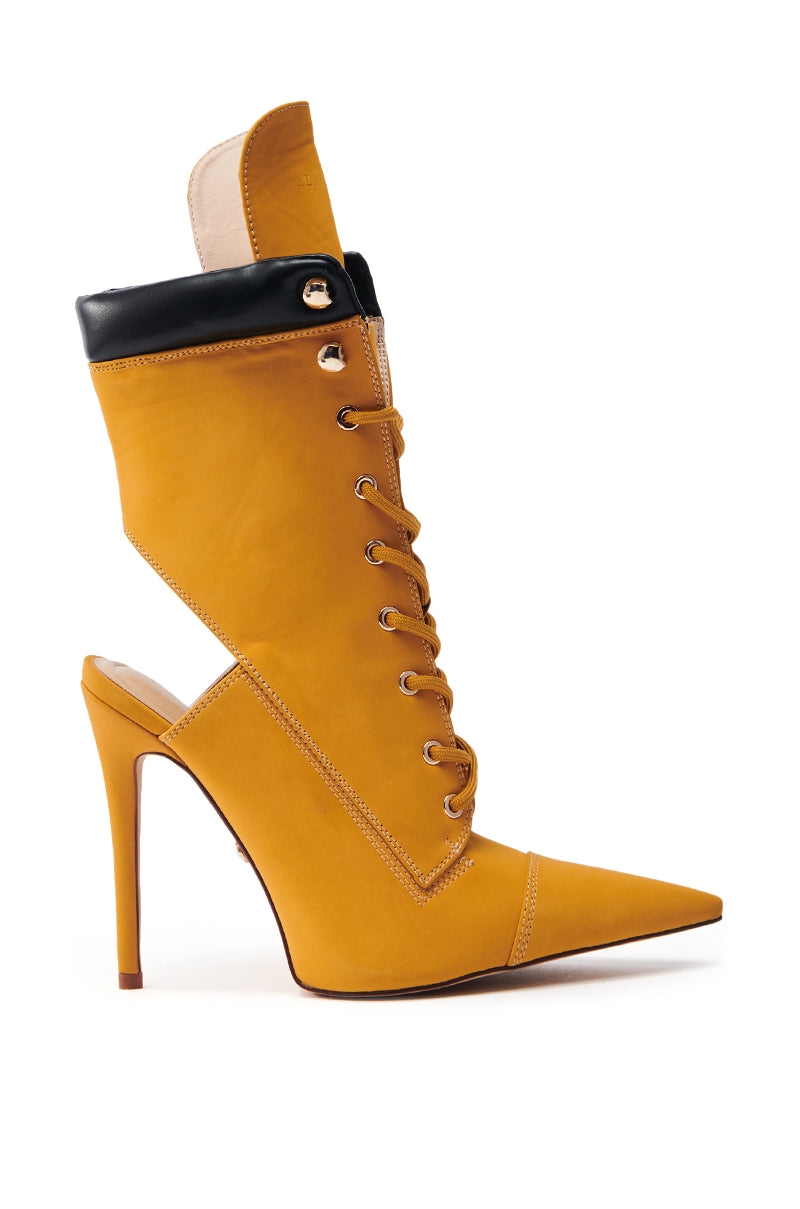 Introducing the AZALEA WANG XIOMARA Yellow Lace-Up Stiletto Bootie: a chic blend of boot and heel in mustard yellow vegan leather, featuring a pointed toe, lace-up panel, open back with a black collar, and tall slender heel.