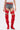 A person stands against a plain light background wearing a white crop top, denim shorts with red belted straps, and the AZALEA WANG XOMARIA RED FAUX SUEDE WESTERN CHAP BOOT—thigh-high with pointed toes and chunky heels.