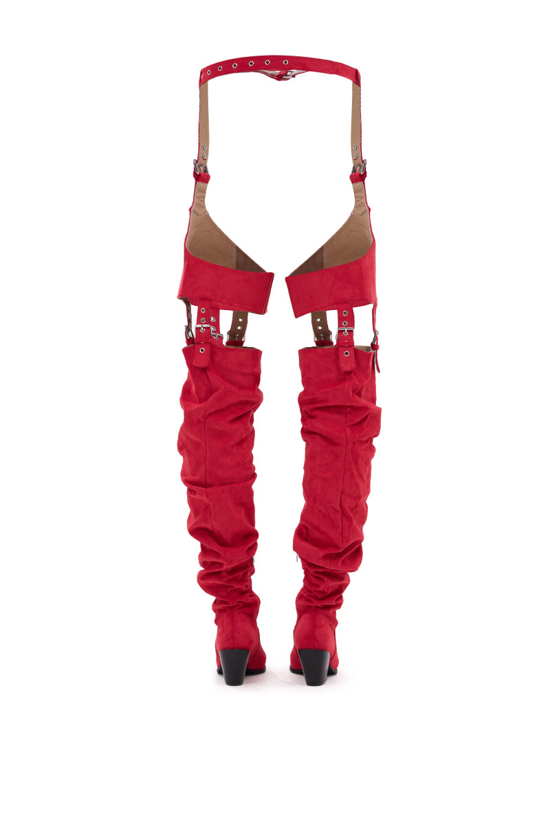 The AZALEA WANG XOMARIA Red Faux Suede Western Chap Boot features bright red thigh-high slouchy legs and brown leather straps forming a garter belt, standing upright on a white background. 8